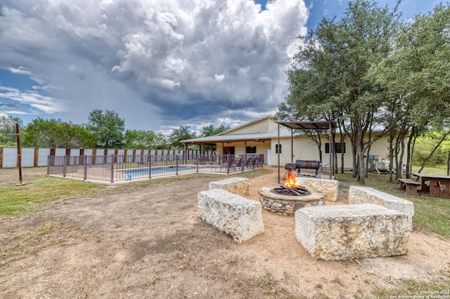 view of pool featuring a patio and a fire pit