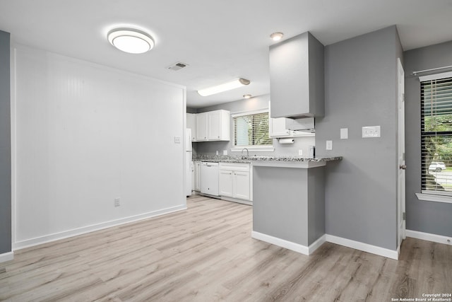 kitchen featuring a healthy amount of sunlight, white dishwasher, white cabinetry, and light hardwood / wood-style flooring