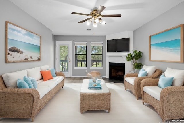 living room featuring ceiling fan and light hardwood / wood-style flooring