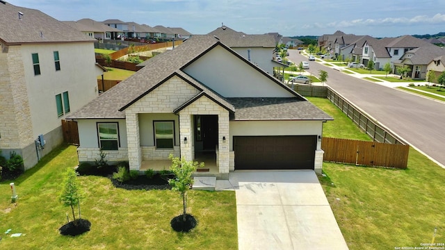 view of front facade with a front yard and a garage