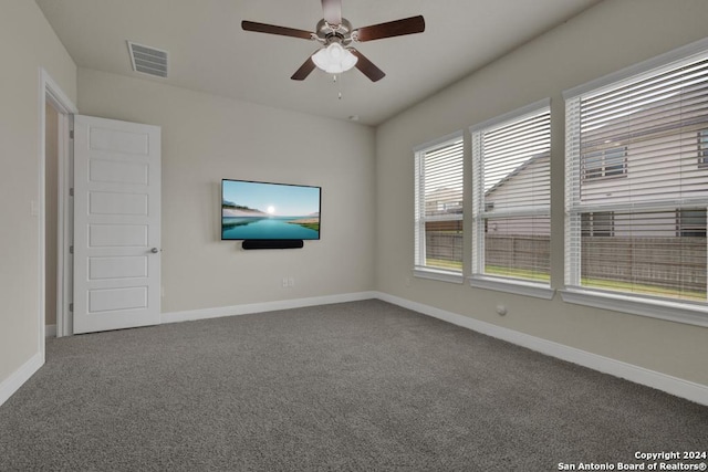 carpeted spare room with ceiling fan