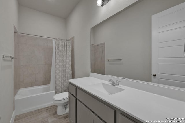 full bathroom with toilet, wood-type flooring, vanity, and shower / bath combo