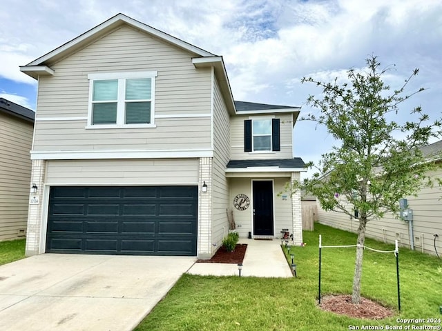 view of front of property with a front lawn and a garage