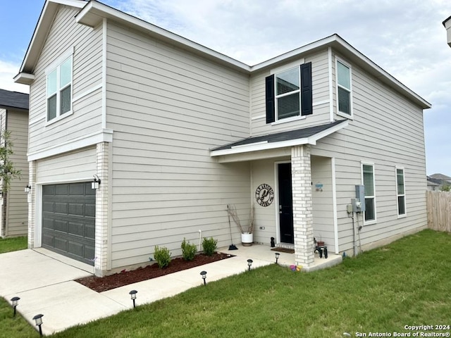 view of front of property with a front lawn and a garage