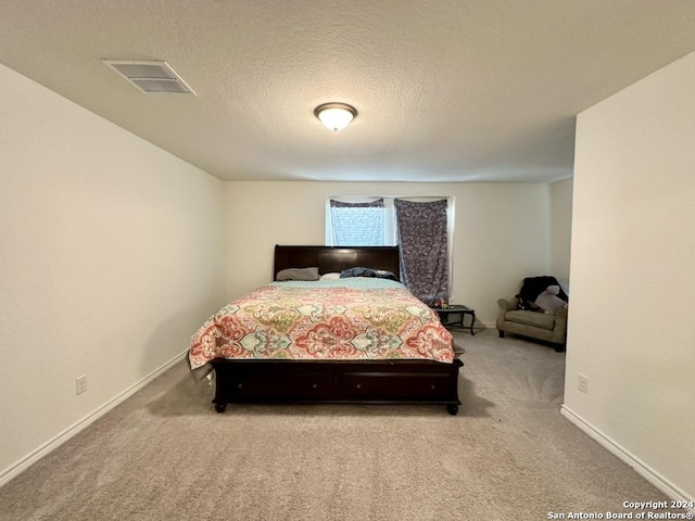 carpeted bedroom with a textured ceiling