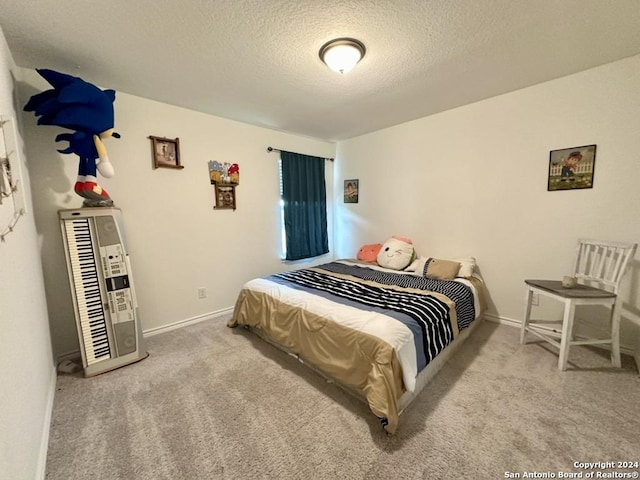 bedroom with a textured ceiling and light carpet