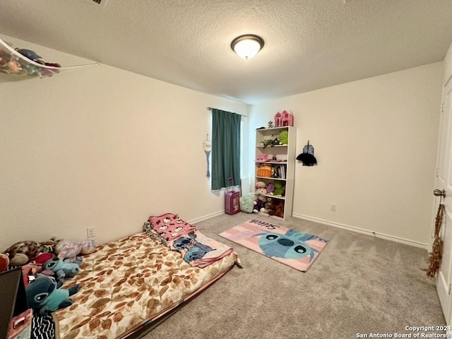 bedroom featuring a textured ceiling and carpet flooring