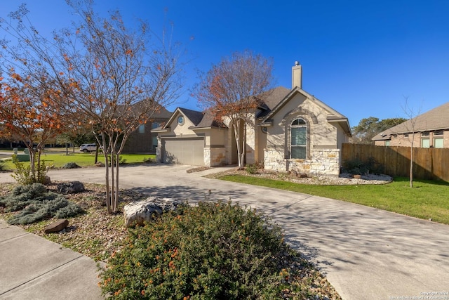 view of front facade with a garage and a front lawn