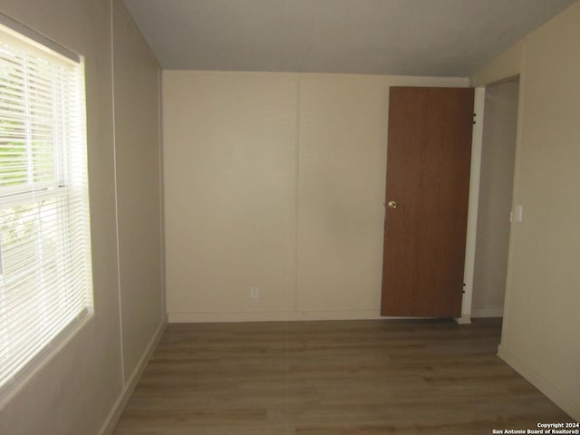 unfurnished room featuring wood finished floors and baseboards