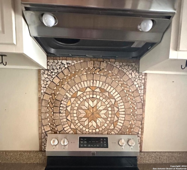 room details featuring white cabinets and stainless steel electric range oven