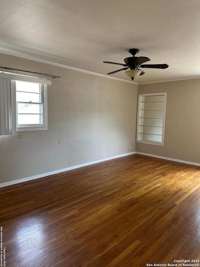 spare room featuring ceiling fan, ornamental molding, and dark hardwood / wood-style flooring