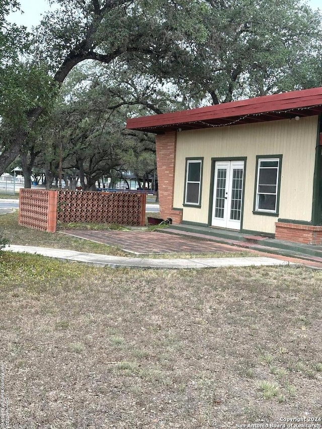 view of property exterior featuring french doors