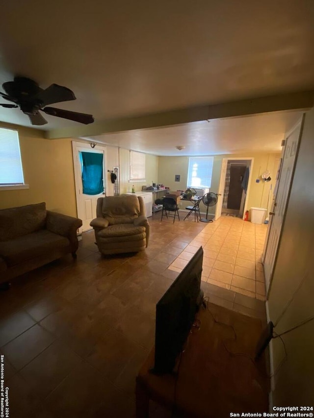 tiled living room with ceiling fan