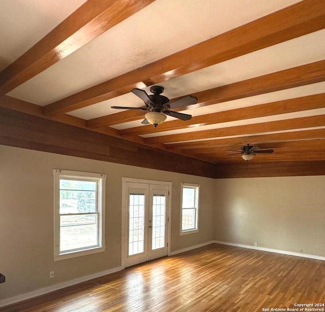 unfurnished room featuring french doors, ceiling fan, a healthy amount of sunlight, and hardwood / wood-style floors