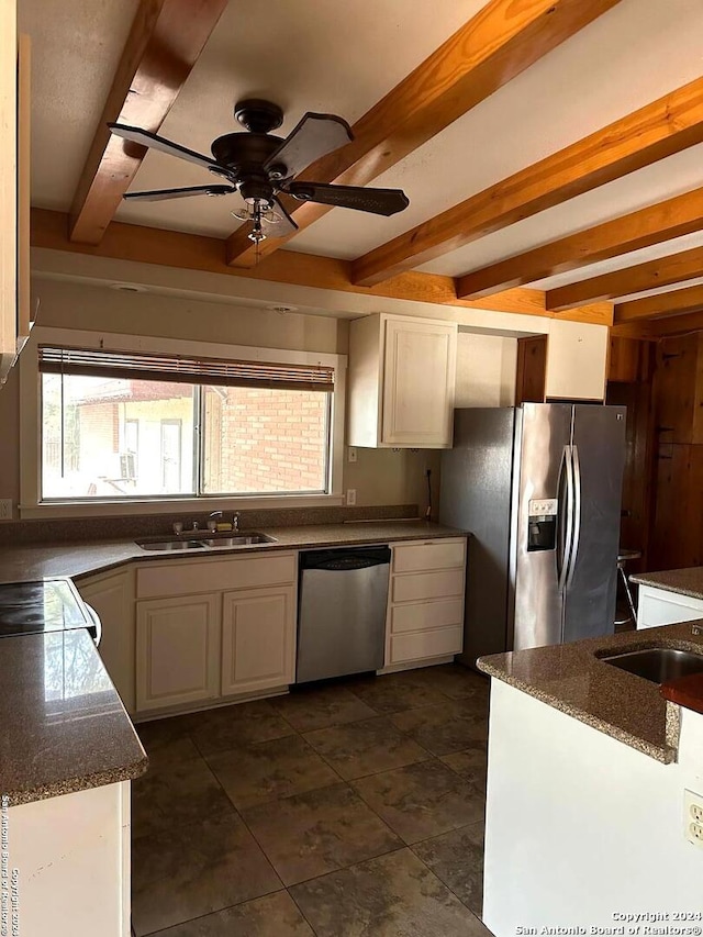 kitchen with sink, white cabinets, ceiling fan, stainless steel appliances, and beam ceiling