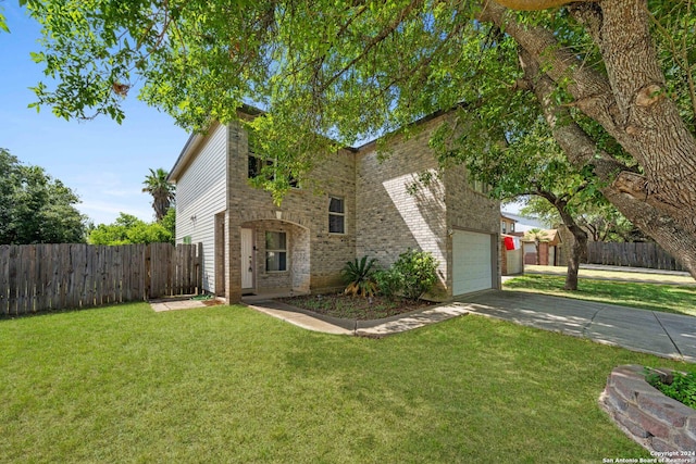 view of front of house with a garage and a front yard