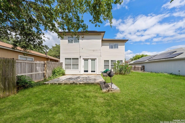 rear view of house with a patio area and a yard