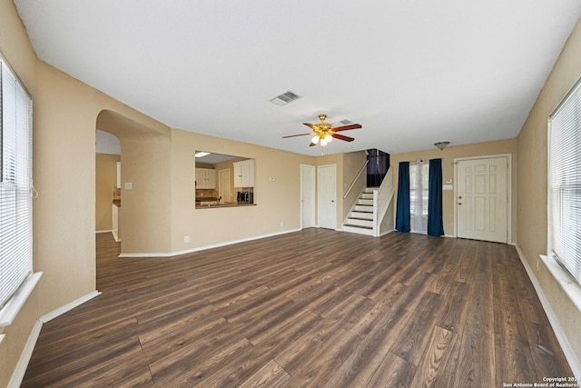 unfurnished living room with ceiling fan and dark hardwood / wood-style floors