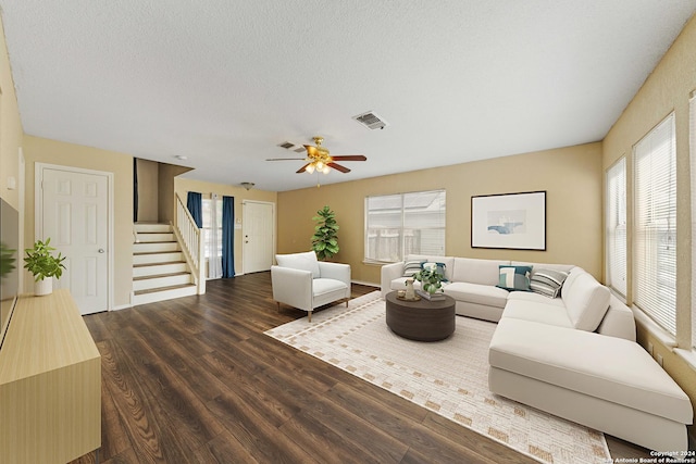 living room featuring a textured ceiling, ceiling fan, and wood-type flooring