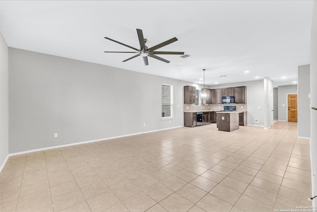 unfurnished living room featuring light tile patterned flooring and ceiling fan