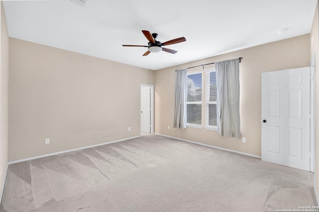 unfurnished room with ceiling fan and light carpet