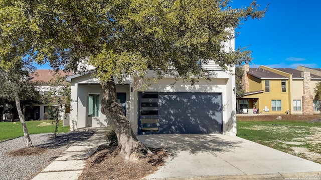 view of front of property featuring a garage and a front lawn