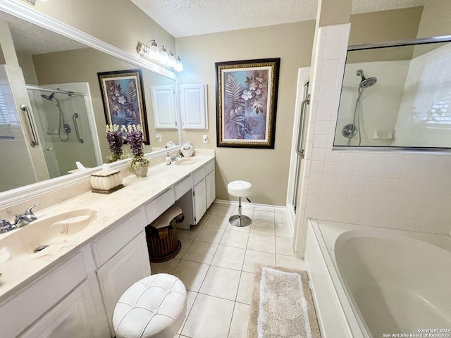 full bathroom with a garden tub, double vanity, a sink, a textured ceiling, and tile patterned flooring