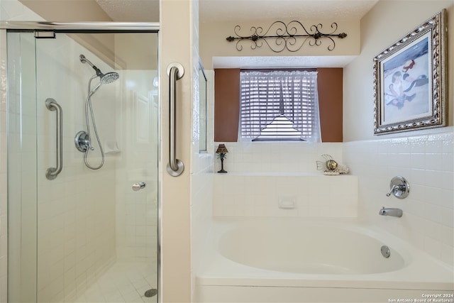 full bathroom featuring a stall shower and a bath