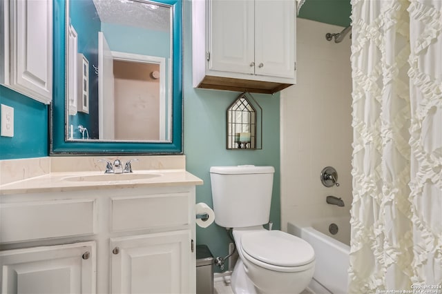 bathroom featuring toilet, shower / bath combo with shower curtain, a textured ceiling, and vanity