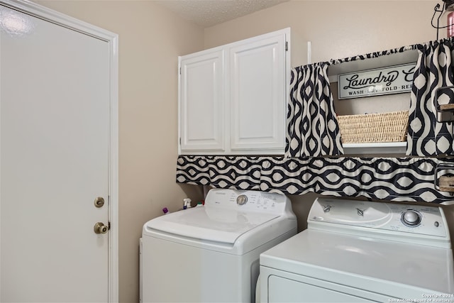 clothes washing area featuring cabinet space, a textured ceiling, and independent washer and dryer