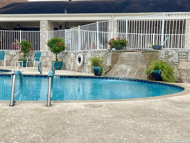 pool featuring a patio area and fence