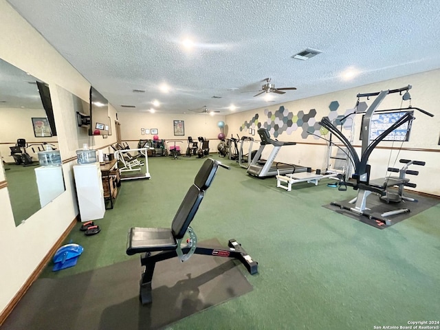 workout area with a textured ceiling, ceiling fan, and visible vents