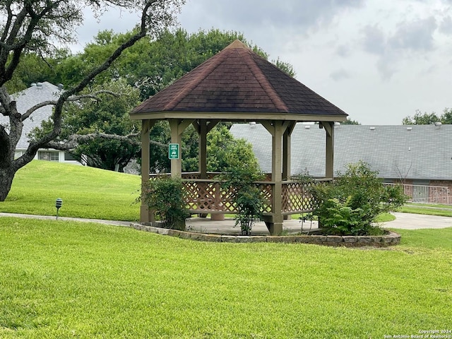 surrounding community with a gazebo and a yard