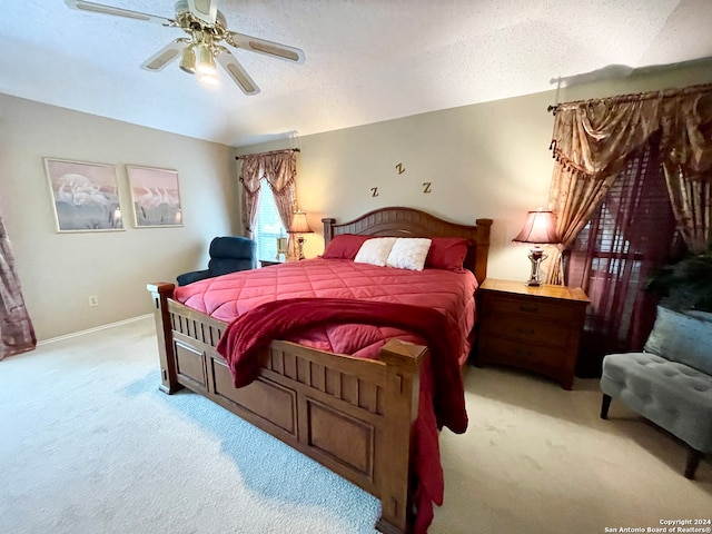 bedroom featuring carpet floors, a textured ceiling, and ceiling fan