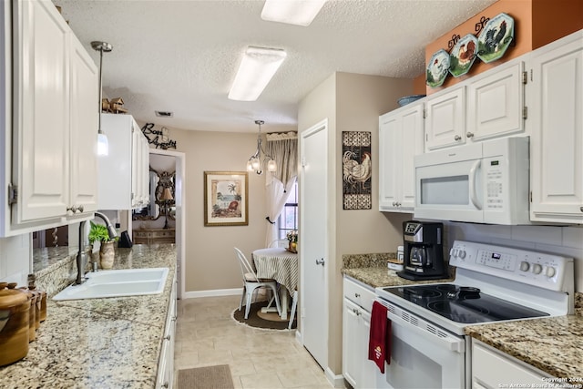 kitchen featuring white appliances, a sink, white cabinetry, and pendant lighting