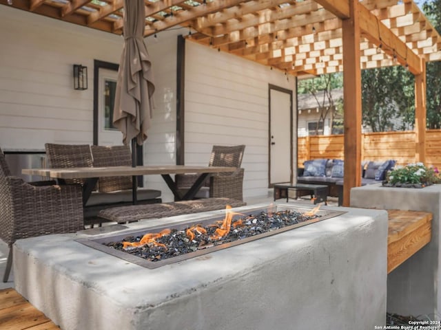 view of patio featuring an outdoor living space with a fire pit and a pergola