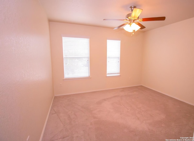 spare room featuring carpet floors and ceiling fan