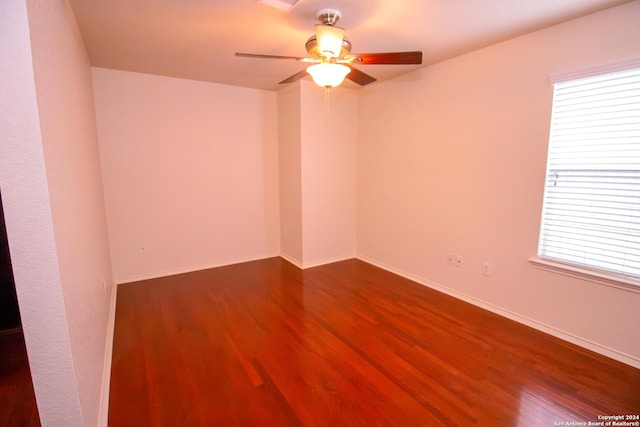 spare room featuring hardwood / wood-style floors, ceiling fan, and a wealth of natural light