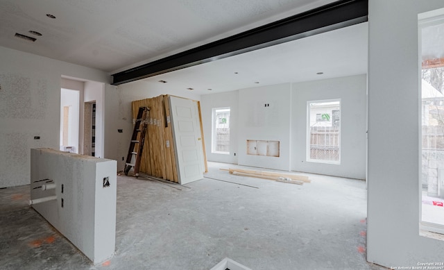 unfurnished living room with concrete floors