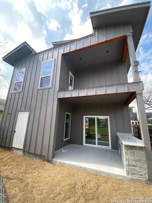 back of property featuring a patio