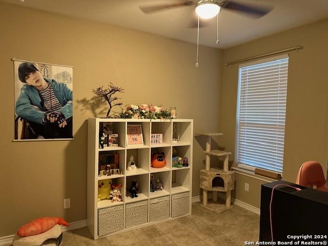 recreation room featuring light tile patterned flooring and ceiling fan