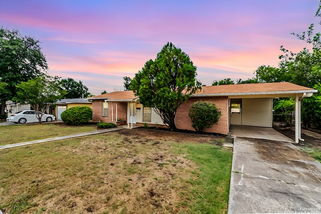 ranch-style home featuring a yard and a carport