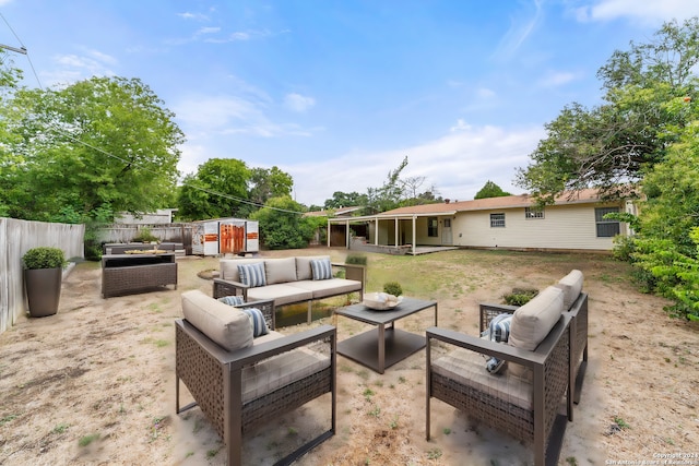 view of patio with outdoor lounge area and a storage shed