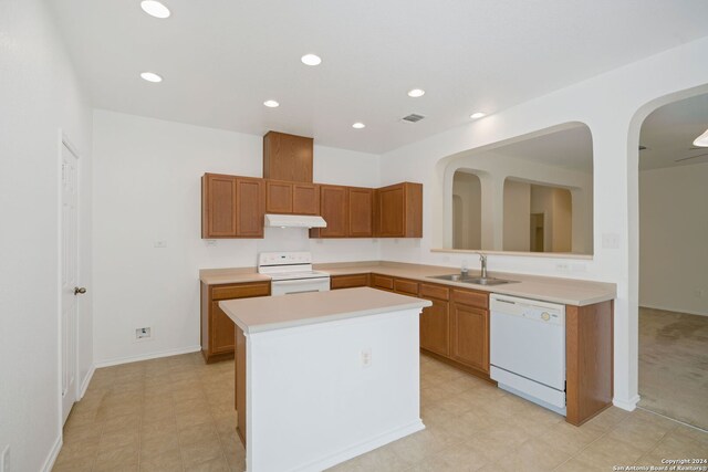 kitchen featuring sink, kitchen peninsula, white appliances, and light tile patterned floors