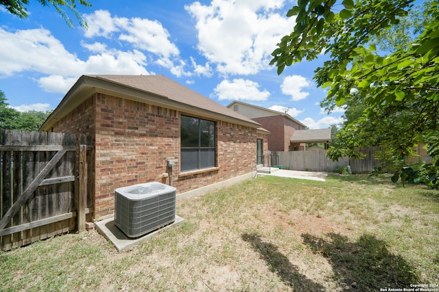 exterior space featuring a lawn and cooling unit