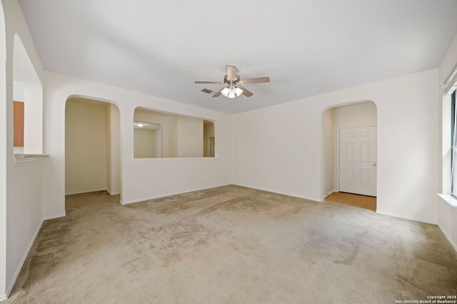 carpeted empty room featuring ceiling fan