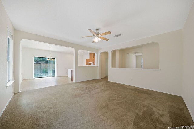 carpeted empty room with ceiling fan