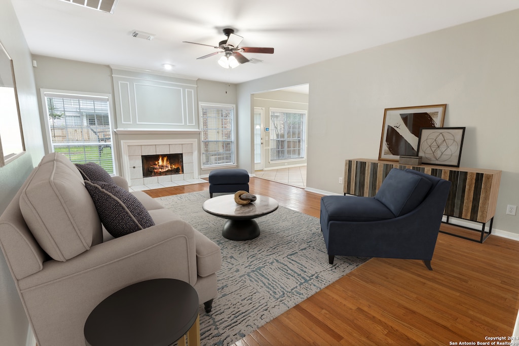 1145 Mesa Blanca, San Antonio, TX 78248 - living room with light hardwood / wood-style floors, a tile fireplace, and ceiling fan