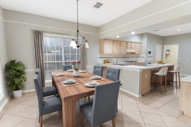 tiled dining area featuring sink