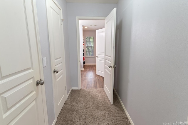 hallway featuring dark carpet